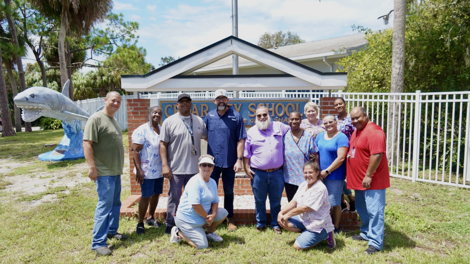 Commissioner Diaz and Levy County Superintendent Christopher Cowart with district staff in front of Cedar Key School.